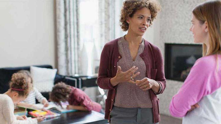 Mom giving babysitting instructions to nanny.