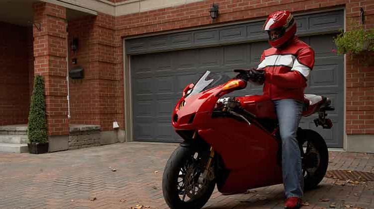 A rider sitting on a red motorcycle