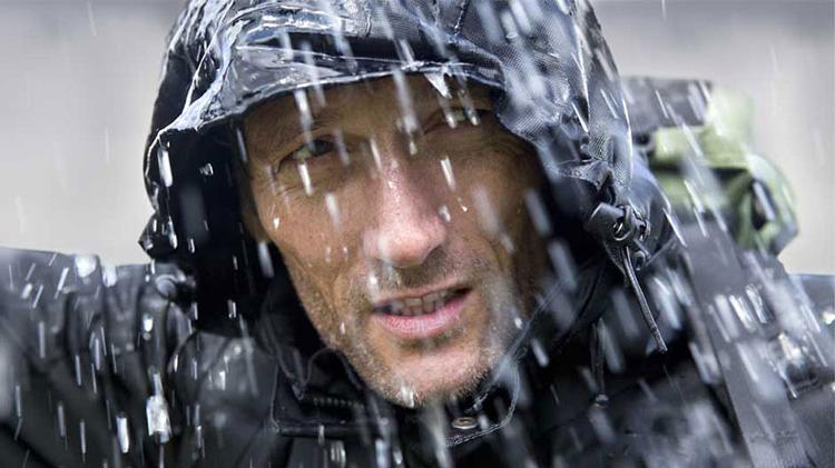 Man in rain gear during a storm.